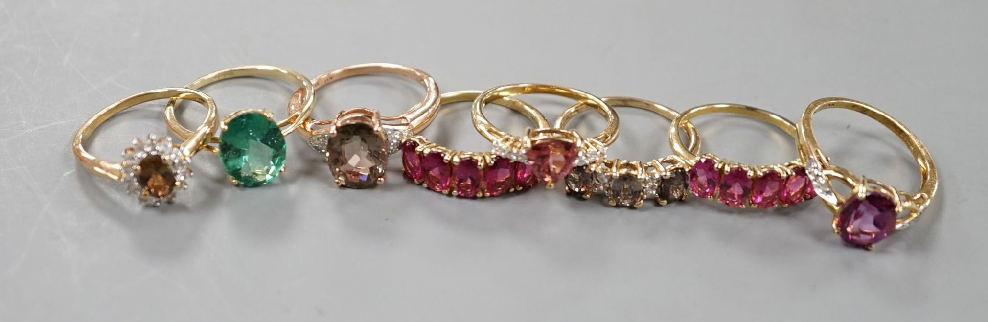Seven assorted modern 9ct gold and gem set dress rings, including rubellite and a 14ct gold and garnet ring